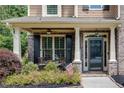 Charming front porch with brick columns, seating, and a well-maintained landscaped garden at 204 Arthur Hills Dr, Acworth, GA 30101