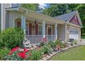 Charming front porch with a lovely garden and manicured flowerbed at 2416 Hurt Sw Rd, Marietta, GA 30008