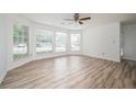 Bright, airy living room featuring large windows, hardwood floors and a ceiling fan at 1306 Red Deer Way # 246, Alpharetta, GA 30022
