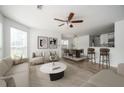 Bright living room with hardwood floors, modern furnishings, ceiling fan, and access to dining area at 1306 Red Deer Way # 246, Alpharetta, GA 30022