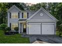 Charming two-story home with a two-car garage, well-maintained lawn, and classic architectural details at 4104 Glenaire Nw Way, Acworth, GA 30101