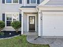 Inviting front entrance with a black door, sidelights, and manicured bushes at 4104 Glenaire Nw Way, Acworth, GA 30101
