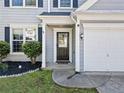 Inviting front entrance with a stylish black door, decorative sidelight, and a well-manicured garden bed at 4104 Glenaire Nw Way, Acworth, GA 30101