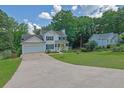 Inviting two-story home with blue shutters, attached garage, and a lush green lawn at 7155 Bannister Park Ln, Cumming, GA 30028