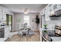 Inviting dining area adjacent to the kitchen, featuring a round table and stylish decor at 10213 Tall Pine Ct, Villa Rica, GA 30180