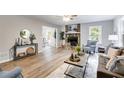 Spacious living room featuring a stone fireplace, hardwood floors, and an open layout at 10213 Tall Pine Ct, Villa Rica, GA 30180