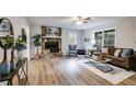 Bright living room with hardwood floors, stone fireplace, and modern furnishings at 10213 Tall Pine Ct, Villa Rica, GA 30180