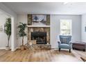 Cozy living room with stone fireplace, large windows, and comfortable seating at 10213 Tall Pine Ct, Villa Rica, GA 30180