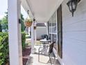 Cozy front porch with outdoor seating, hanging plants, and stylish lighting, great for relaxing at 566 Lullingstone Se Dr, Marietta, GA 30067