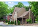 Beautiful brick home with stone accents, lush greenery, and a welcoming facade providing great curb appeal at 580 Cliftwood Ct, Sandy Springs, GA 30328