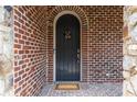 Elegant front door with stone and brick details, creating a grand entrance to the home at 580 Cliftwood Ct, Sandy Springs, GA 30328