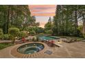 Backyard oasis featuring a pool, hot tub, well manicured landscaping, and lake views at 1240 Bridgewater Walk, Snellville, GA 30078
