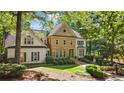 Stately stone and stucco home nestled in lush greenery with mature trees and fountain landscaping at 1240 Bridgewater Walk, Snellville, GA 30078
