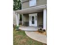 Inviting front porch features an ornate glass front door, outdoor seating and manicured landscaping at 2320 Glynmoore Dr, Lawrenceville, GA 30043
