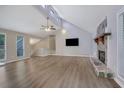 Spacious living room with vaulted ceilings, stone fireplace, and wood-look flooring at 2673 Deerfield Sw Cir, Marietta, GA 30064
