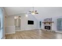 Bright living room with vaulted ceilings, stone fireplace, and wood-look flooring at 2673 Deerfield Sw Cir, Marietta, GA 30064