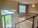 Bright foyer with hardwood floors, chandelier, and view of the front yard through a large window at 775 Brand South Trl, Lawrenceville, GA 30046