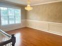 Living room showcasing hardwood floors and a large window providing ample natural light at 775 Brand South Trl, Lawrenceville, GA 30046