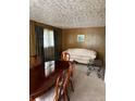 Traditional dining room with wood paneling, patterned wallpaper, and elegant dining set at 3127 Latona Sw Dr, Atlanta, GA 30354