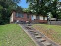 View of exterior elevation with long staircase, brick facade, and charming curb appeal at 3127 Latona Sw Dr, Atlanta, GA 30354