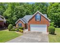 Lovely one-story brick home boasting an attached garage and a meticulously maintained lawn at 415 Stephanie Ct, Stockbridge, GA 30281
