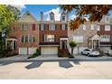 Charming brick townhome with a two-car garage and a well-manicured front yard at 10090 Jones Bridge Rd # 2, Alpharetta, GA 30022