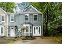 Charming two-story townhome with gray siding, white trim, and a neatly landscaped front yard at 3001 Majestic Park Ct, Duluth, GA 30096