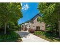 Beautiful, sprawling home featuring a long driveway and exquisite brickwork with professionally landscaped grounds at 3680 Milton Park Dr, Alpharetta, GA 30022
