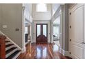 Elegant foyer with soaring ceilings, hardwood floors, and beautiful doors at 3680 Milton Park Dr, Alpharetta, GA 30022