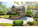 Exterior of a two-story home with a spacious driveway, lush landscaping, and an attached garage at 44 Barbara Ln, Atlanta, GA 30327