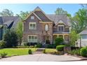 Beautiful two-story home with a stone and brick facade, complemented by a well-maintained lawn at 44 Barbara Ln, Atlanta, GA 30327