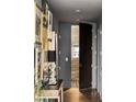 Hallway with dark wood door, patterned floor, and decorative art pieces that add character to the space at 45 Ivan Allen Jr Nw Blvd # 1702, Atlanta, GA 30308