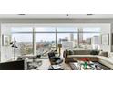 Spacious living room with comfortable seating, stylish decor, and expansive windows showcasing scenic city views at 45 Ivan Allen Jr Nw Blvd # 1702, Atlanta, GA 30308