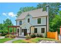 Charming two-story home with a manicured lawn, stone walkway, and a lovely pergola covered porch at 1059 Woodland Ave, Atlanta, GA 30316