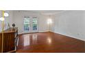 Spacious living room with gleaming hardwood floors and ample natural light from the double doors at 3701 Essex Ave # 2, Atlanta, GA 30339