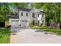 Charming two-story home with a manicured lawn, attached garage, and classic white painted brick exterior at 4331 Volnay Ne Ct, Marietta, GA 30066