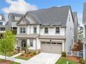 Stunning two-story home boasts an attached garage, covered porch, landscaped yard, and neutral color scheme at 1010 Fendley St, Woodstock, GA 30188