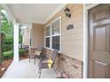 Cozy front porch featuring comfortable seating, brick accents, and a welcoming entrance at 2595 Grapevine Cir, Cumming, GA 30041