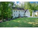 Charming two-story home with a well-manicured lawn and mature trees in a lush neighborhood at 3295 Waters Ml, Alpharetta, GA 30022