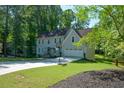 Traditional home featuring a well-maintained lawn, brick-lined stairs, and a two-car garage at 3295 Waters Ml, Alpharetta, GA 30022