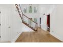 Bright foyer with high ceilings, hardwood floors, and a staircase at 4938 Cedar Lake Ter, Douglasville, GA 30135