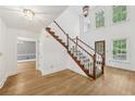 Sunlit foyer featuring hardwood floors, a staircase, and an open layout at 4938 Cedar Lake Ter, Douglasville, GA 30135