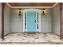 Inviting front porch with stone flooring and a bright blue entrance door at 4938 Cedar Lake Ter, Douglasville, GA 30135