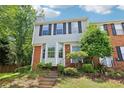 Charming two-story townhouse featuring a bay window, brick accents, and a well-manicured front yard at 1712 Grist Mill Dr, Marietta, GA 30062