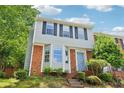 Close up of two-story townhouse featuring a bay window, brick accents, and a well-manicured front yard at 1712 Grist Mill Dr, Marietta, GA 30062
