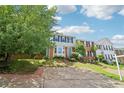 Two-story townhouse with brick and gray siding, complemented by a well-kept lawn and walkway at 1712 Grist Mill Dr, Marietta, GA 30062