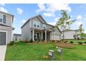 Attractive home with a well-kept lawn and mulch flower beds on a sunny day at 2010 Moonlight Path, Covington, GA 30016