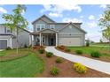 Beautiful home with a well-maintained lawn, complemented by a paved walkway and mulch flower beds at 2010 Moonlight Path, Covington, GA 30016