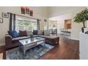 Bright and airy living room featuring large windows, open floor plan, and hardwood flooring at 3725 Falls Trl, Winston, GA 30187