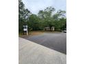 Long driveway leading to a single story home with lush green trees at 4897 Lou Ivy Rd, Peachtree Corners, GA 30096